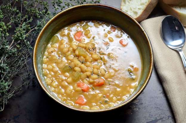 A bowl of white bean soup with a spoon