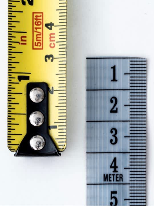 Metal ruler next to a tape measure
