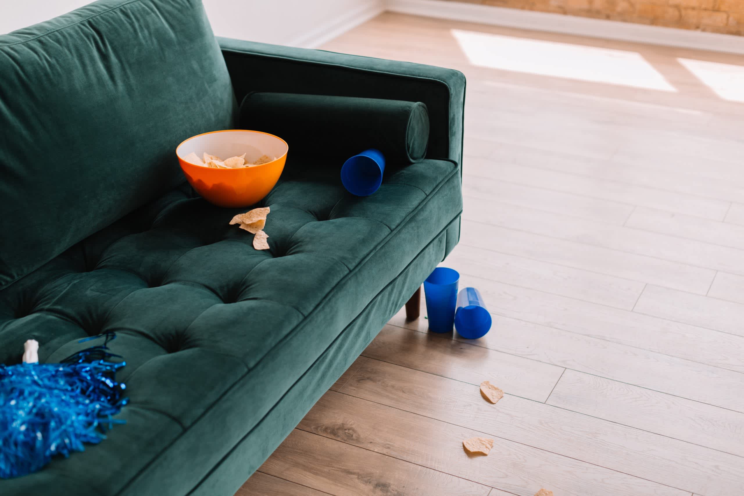 A couch with a bowl of snacks