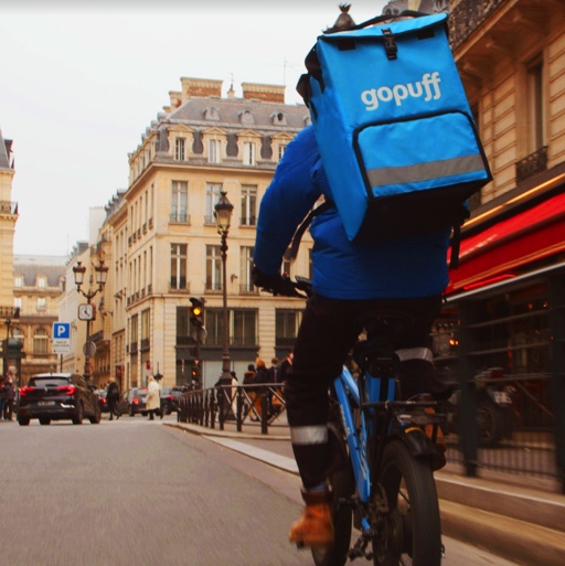 Man on bike with Gopuff backpack