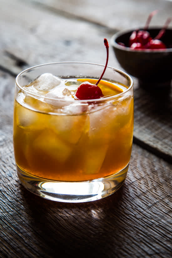 Rocks glass with maple bourbon cocktail