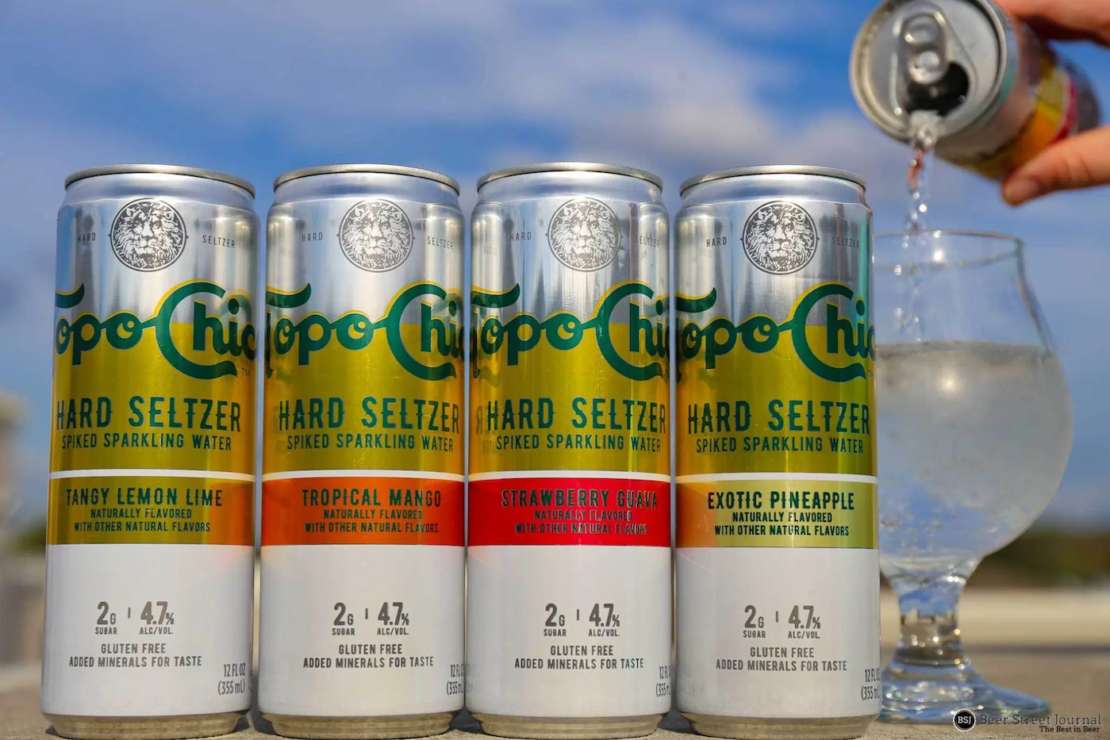 4 Topo Chico Hard Seltzer cans: Lemon Lime, Tropical Mango, Strawberry Guava & Exotic Pineapple 