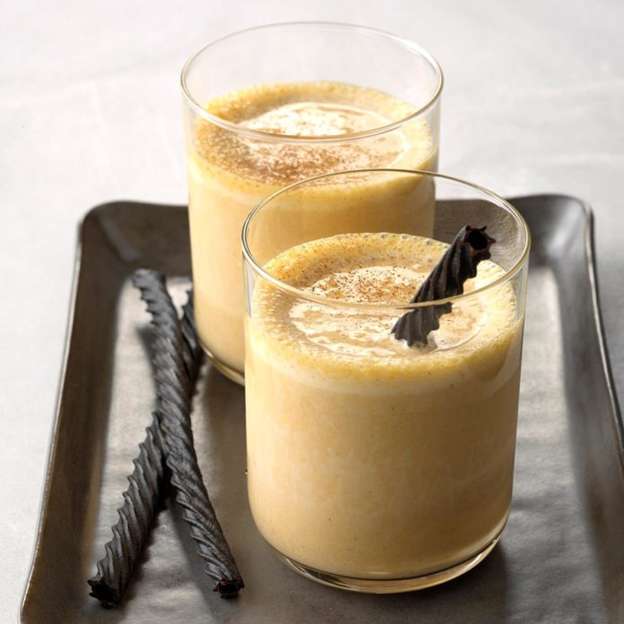 Pumpkin milkshakes served in lowball glasses and garnished with black licorice