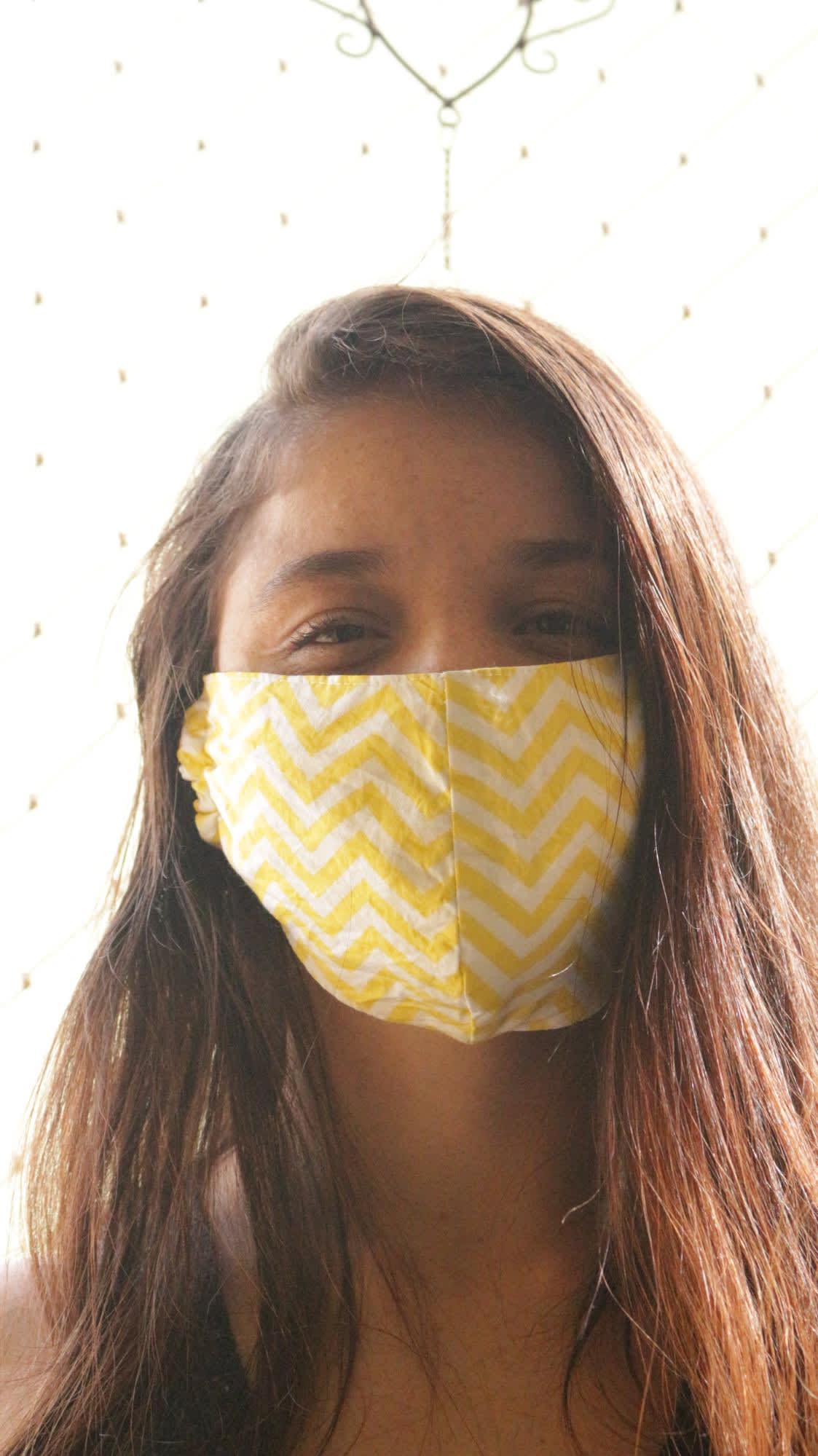 Woman wearing yellow mask