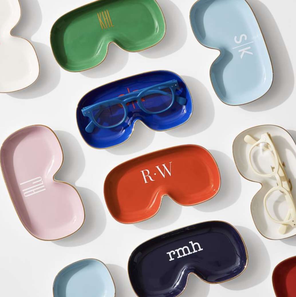 Ten colorful catchall trays with a pair of glasses 