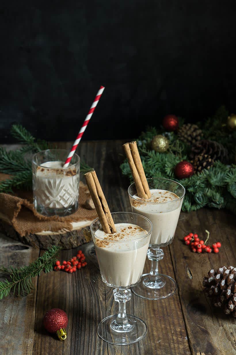 Eggnog on wooden table with Christmas decorations