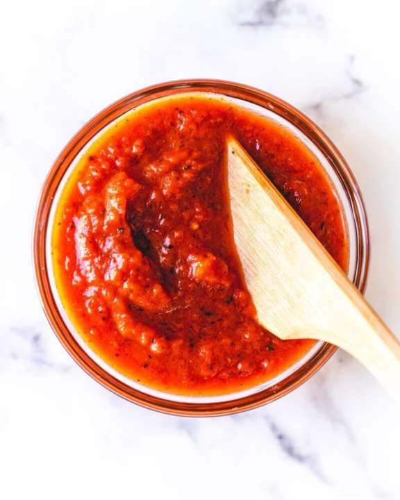 Red pizza sauce in a small bowl