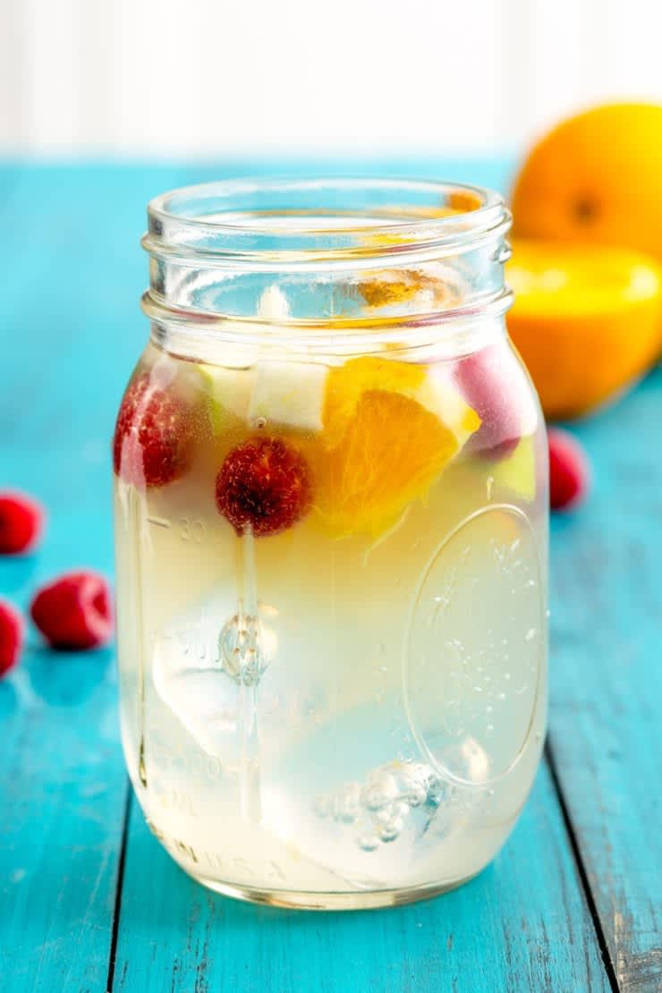 A glass of lemonade sangria with fruit