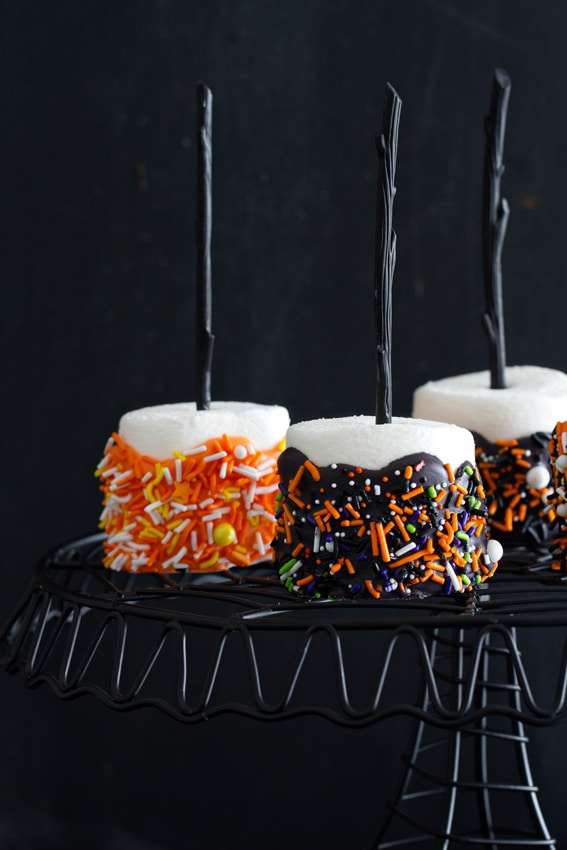 Halloween marshmallow pops on a serving stand