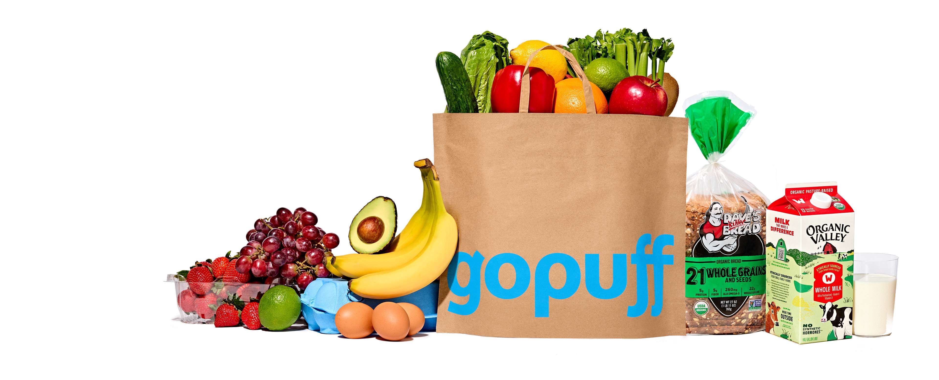 Gopuff bag surrounded by fresh produce, bread and dairy products.