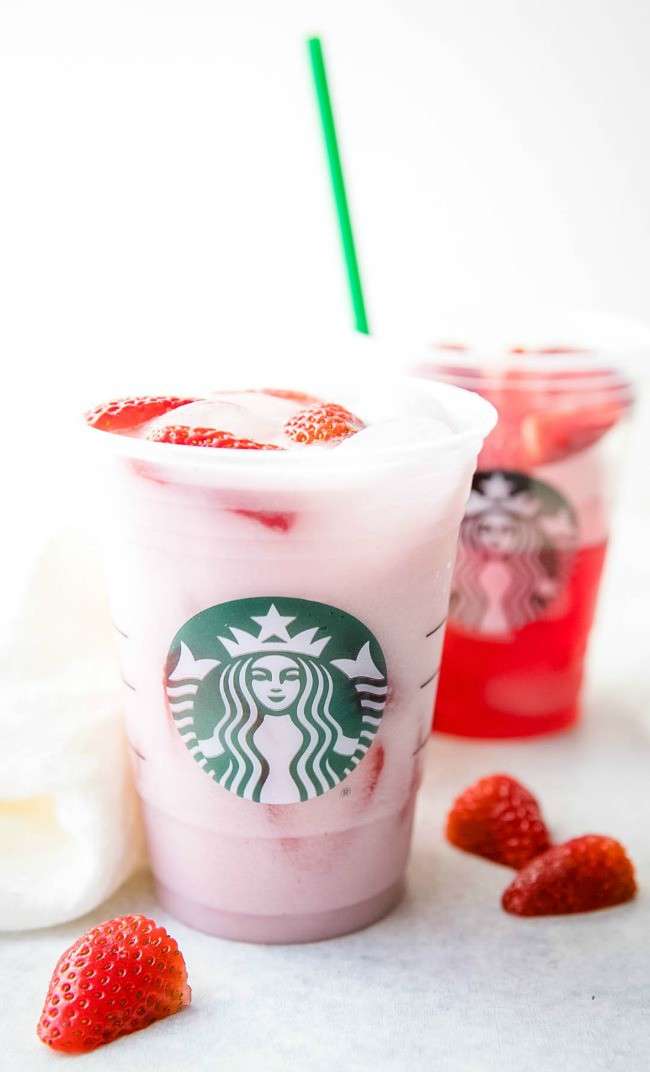 Strawberries and a pink-colored drink in a Starbucks cup