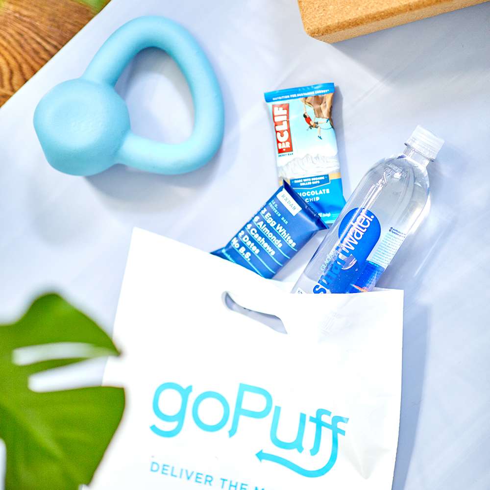 A spread of healthy foods next to a Gopuff bag