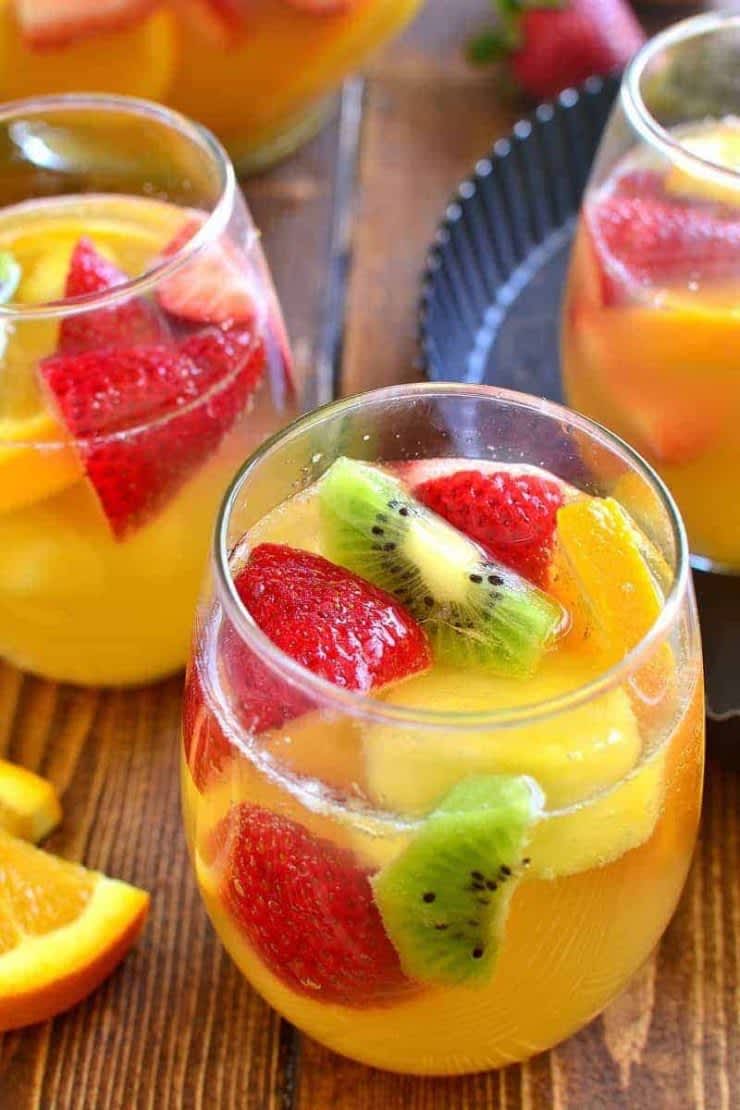 Two glasses of tropical white sangria with fruit