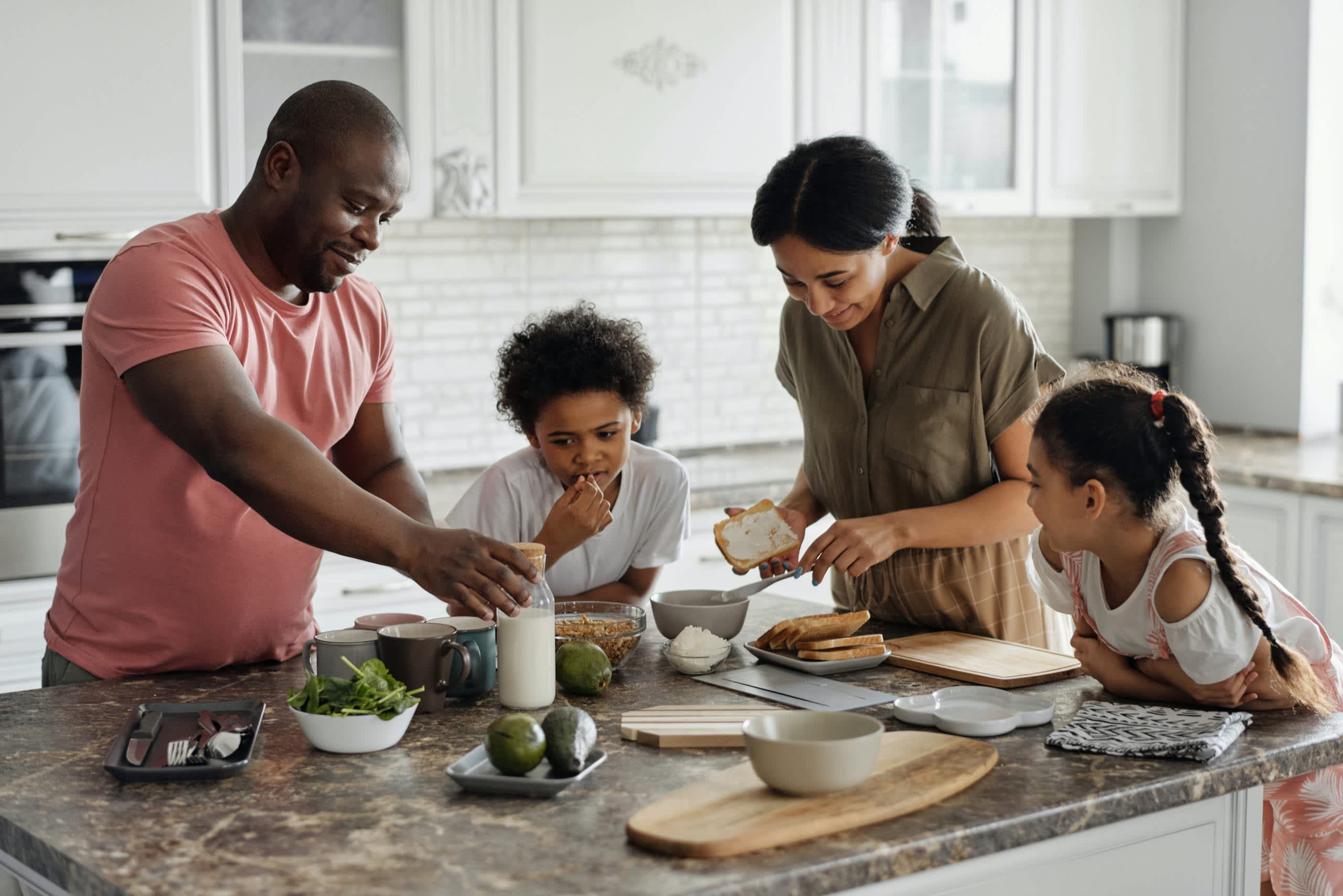 A family making homemade breakfast in a kitchen