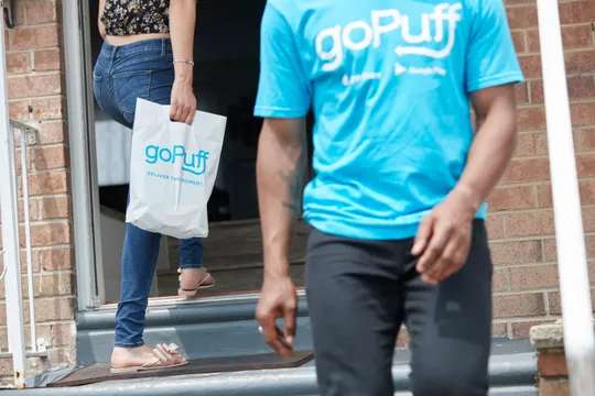 man wearing gopuff tshirt and woman holding gopuff bag