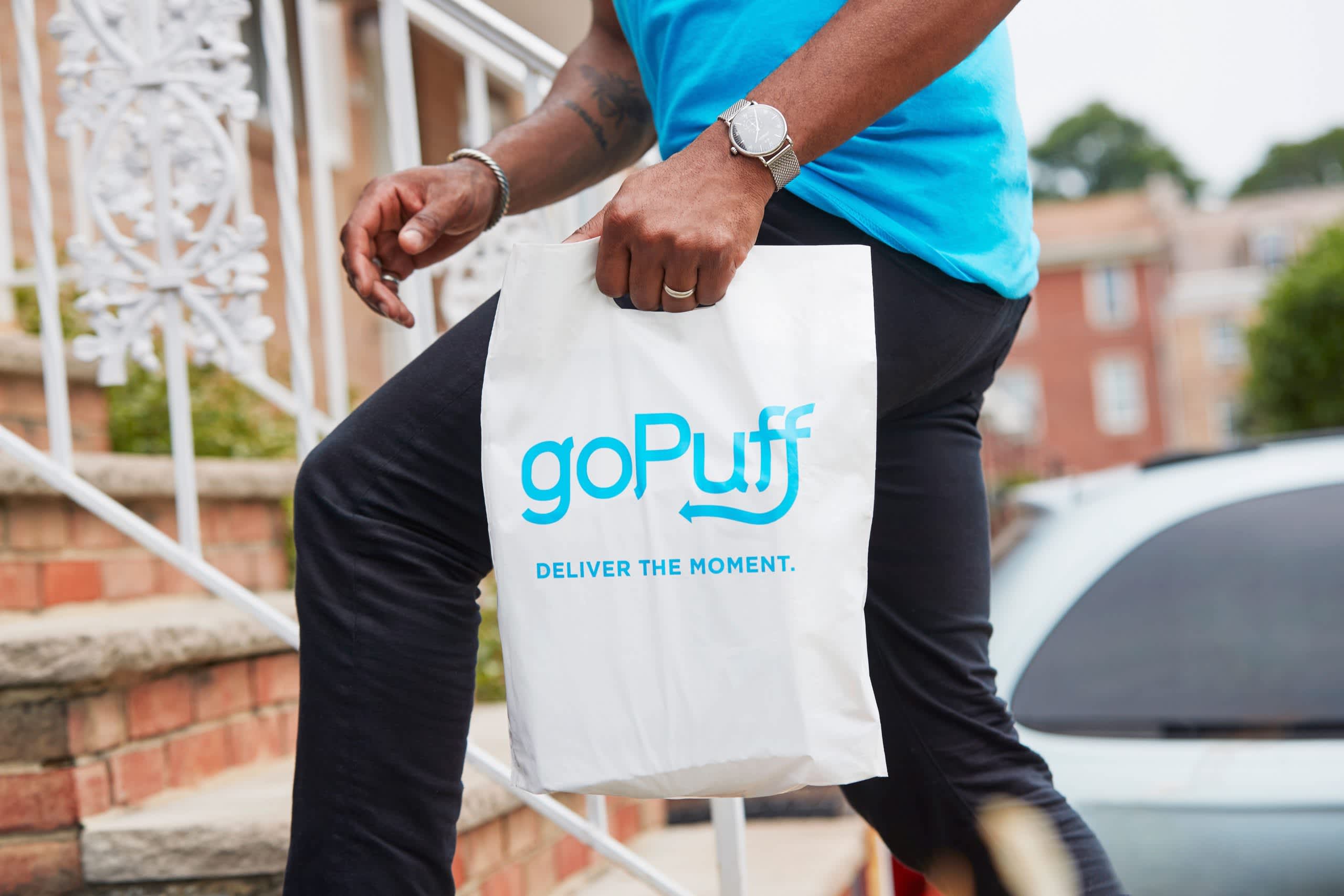 A Gopuff Driver Partner delivering a Gopuff bag of goodies