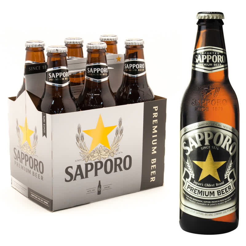 6-Pack of Sapporo Premium Beer bottles next to a single bottle