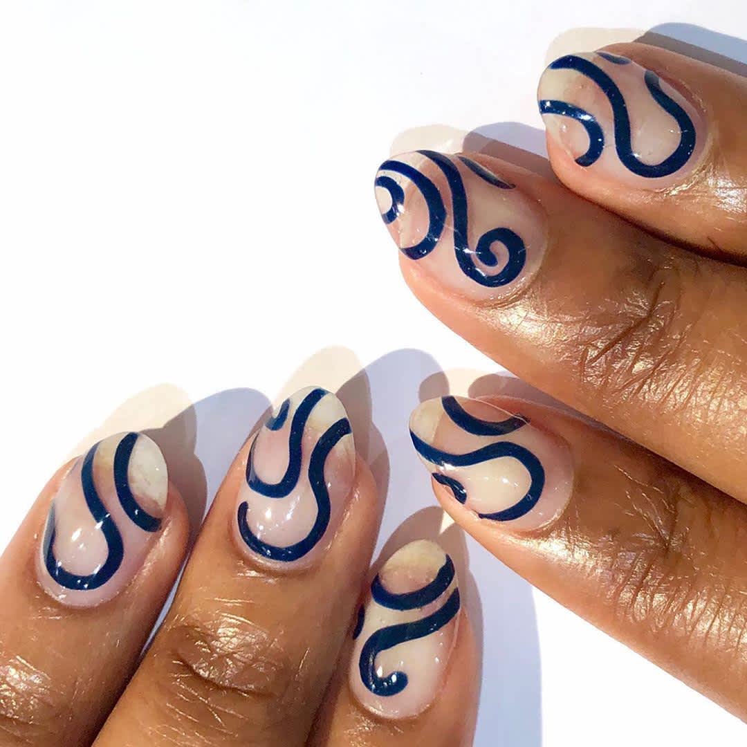 clear nails with navy swirls 