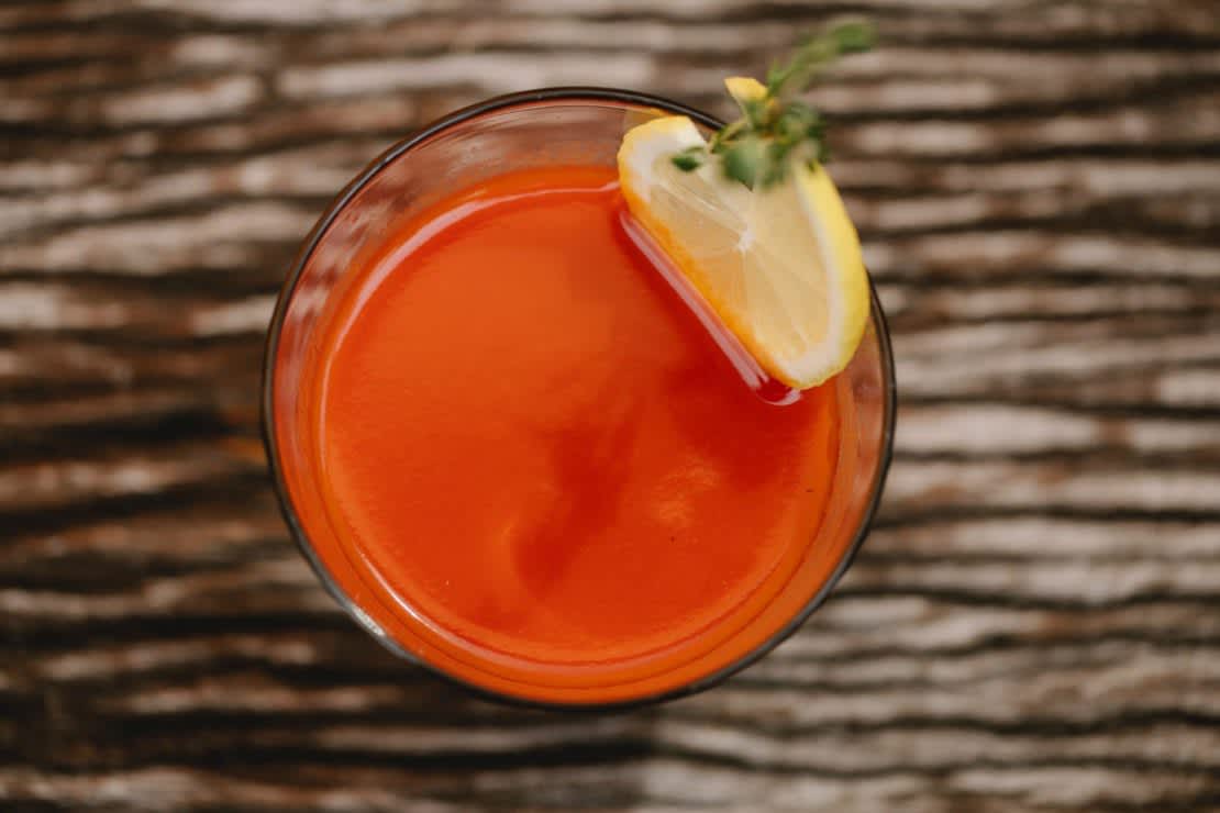 A Bloody Mary cocktail in a glass with a lemon garnish.
