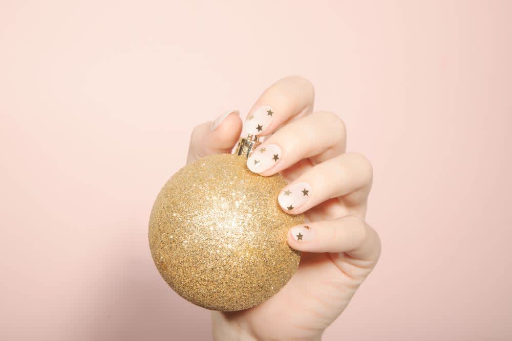 nude nails with tiny gold glitter stars
