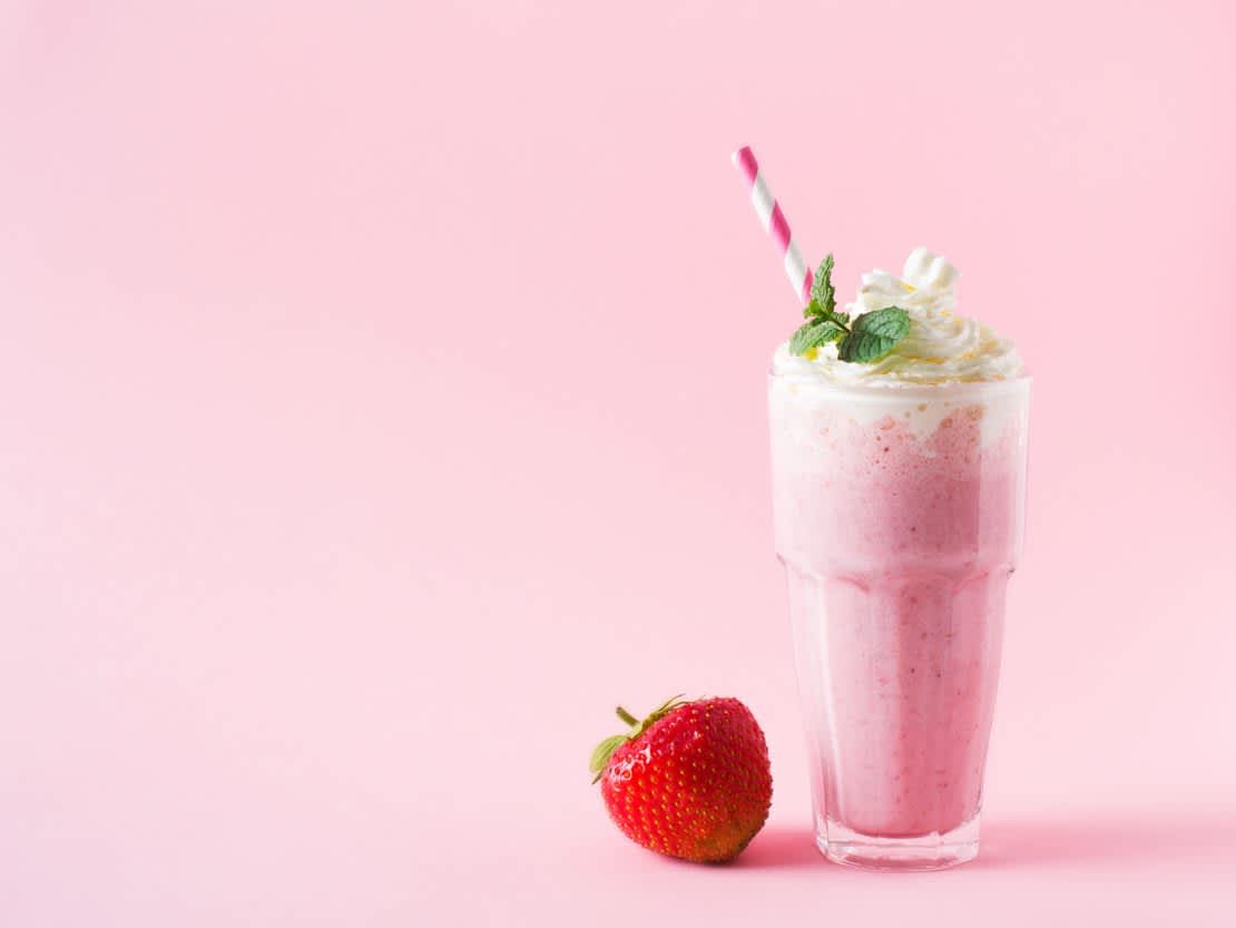 Strawberry milkshake and fresh raw berries