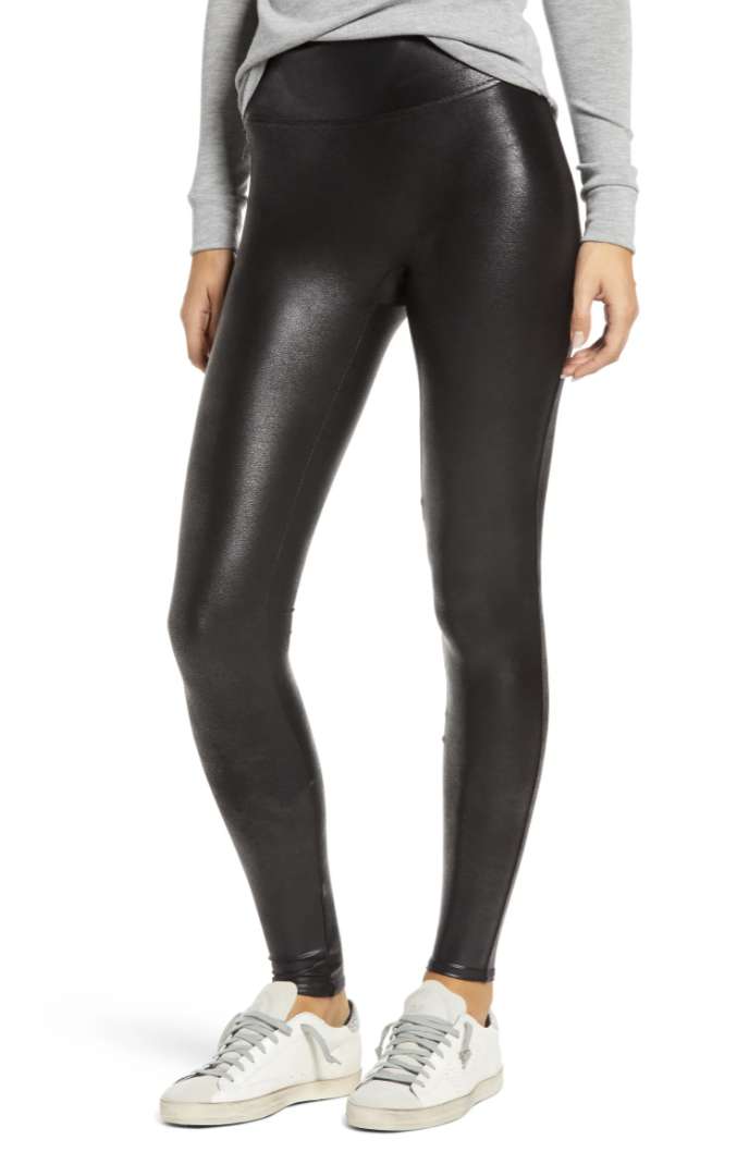 Woman wearing black faux leather leggings 