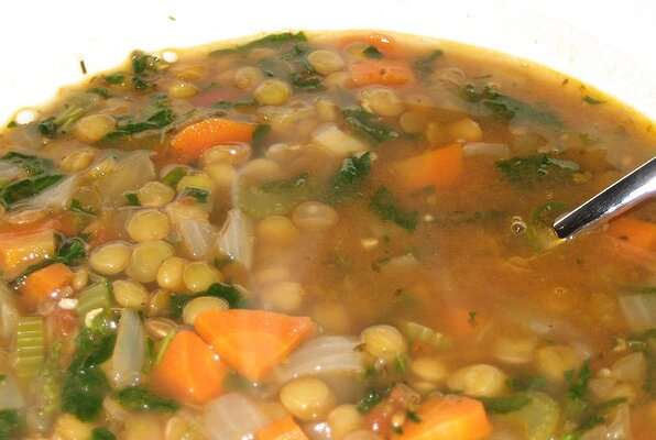 A bowl of lentil soup with a spoon