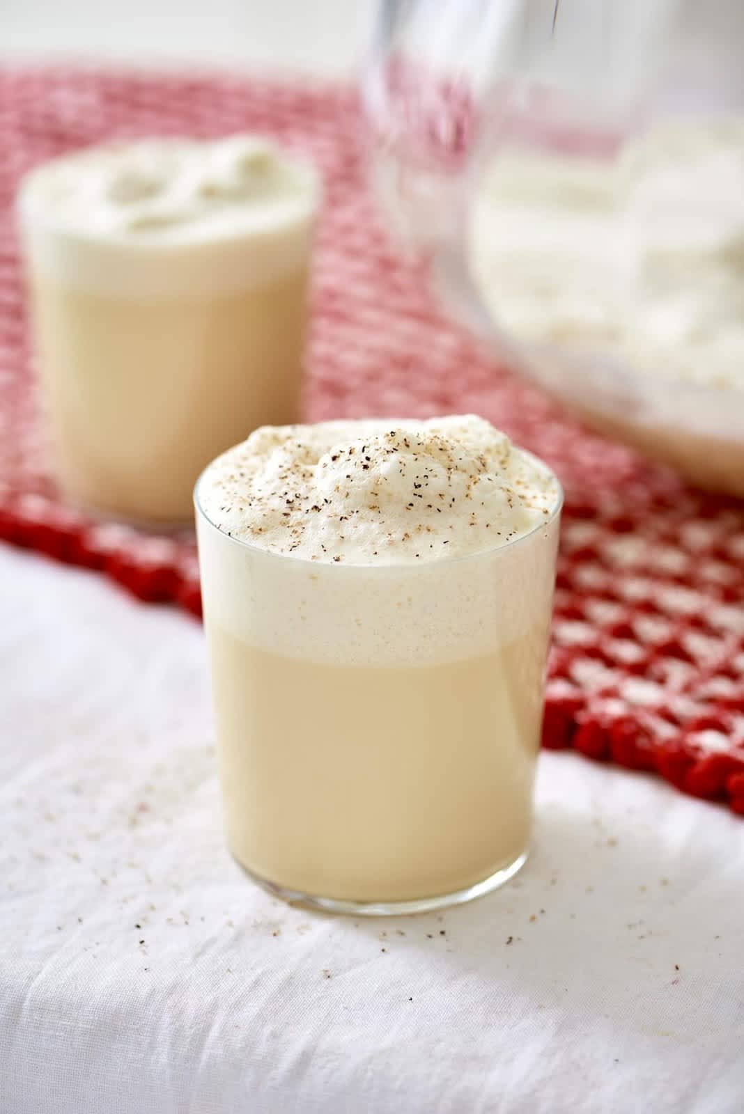 Rocks glass filled with homemade spiked eggnog  