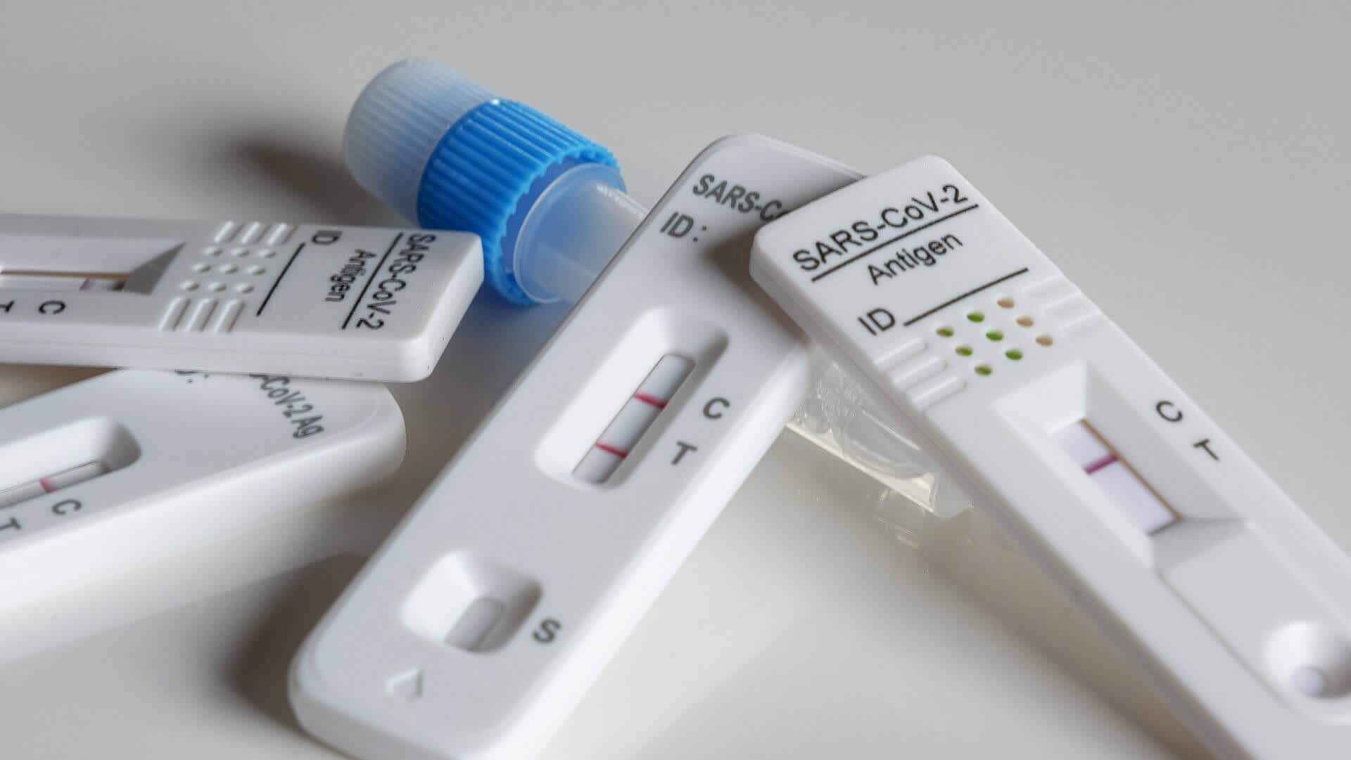 Positive and negative antigen rapid covid tests results on white background