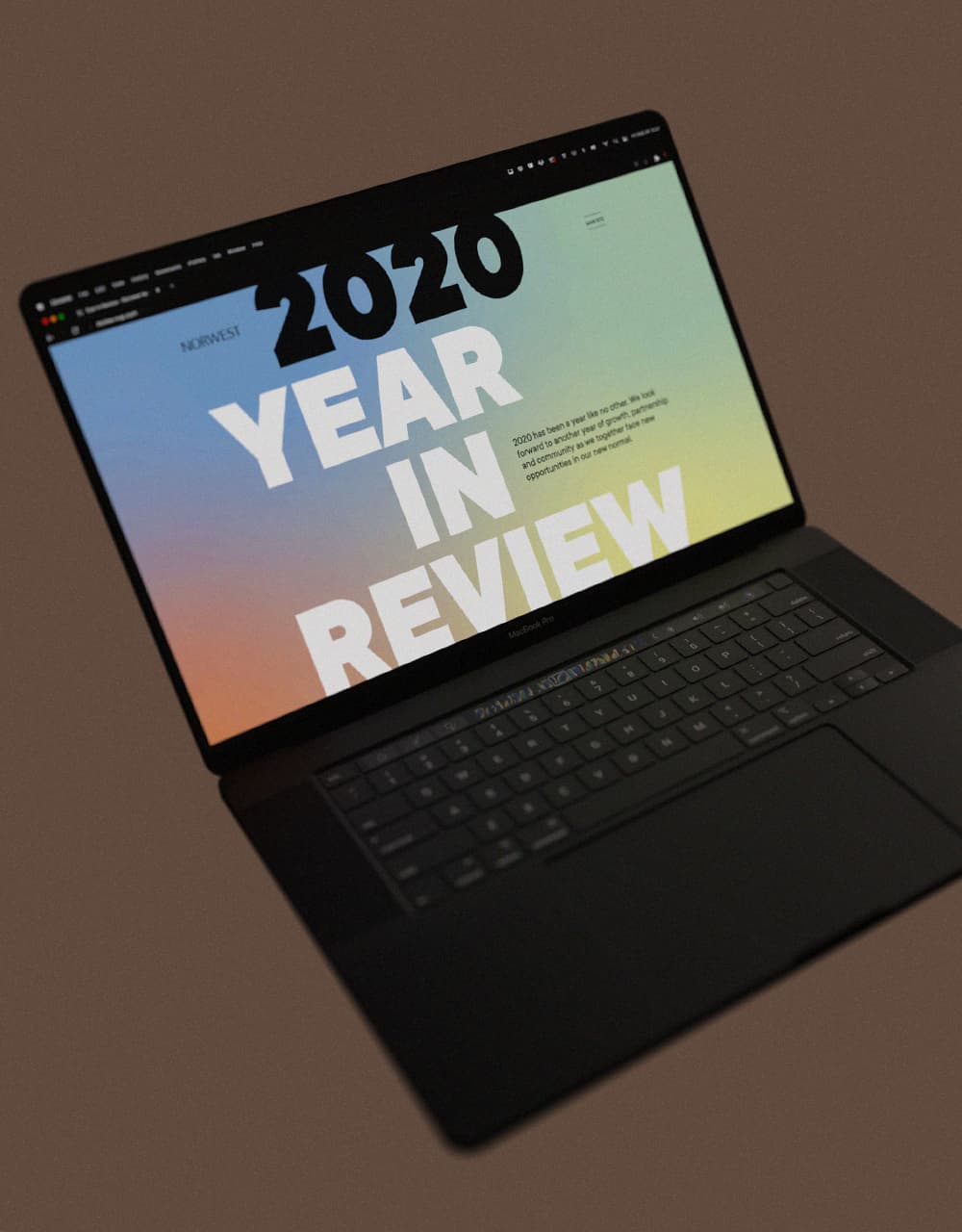 A 3D rendering of a computer with the NVP 2020 Year in Review webpage