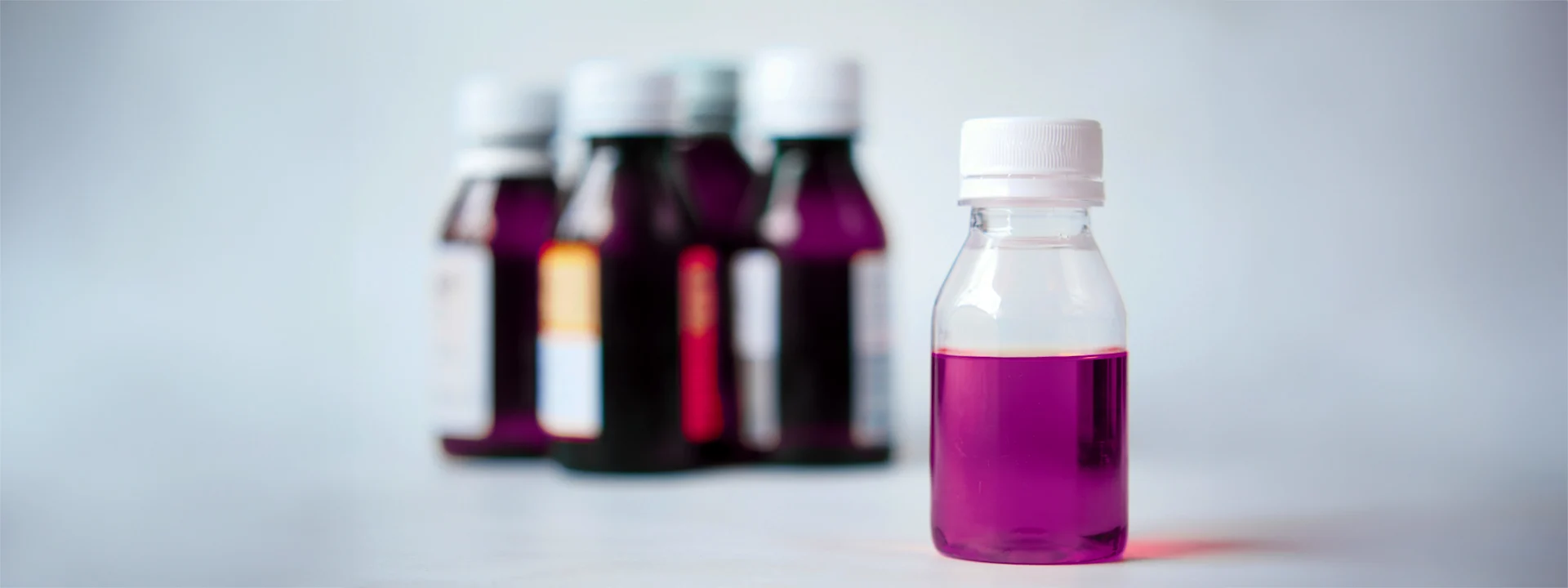 Bouteille de lean en avant-plan avec quatre autres bouteilles en arrière plan.