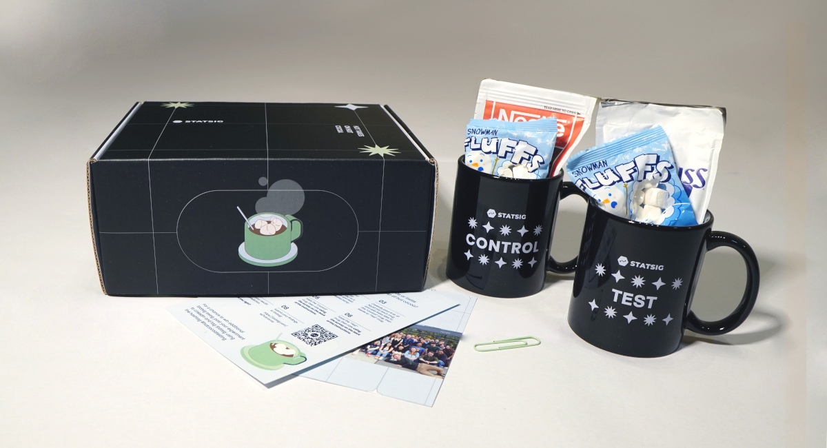 a holiday gift box with two mugs, marshmallows, hot chocolate, and instruction cards