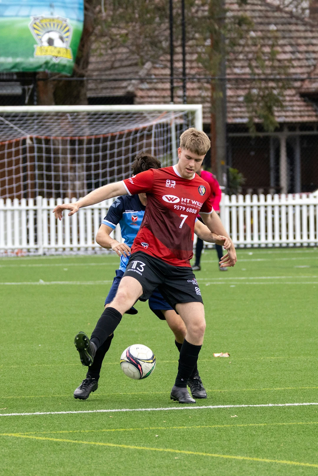 Two soccer players competing for the ball