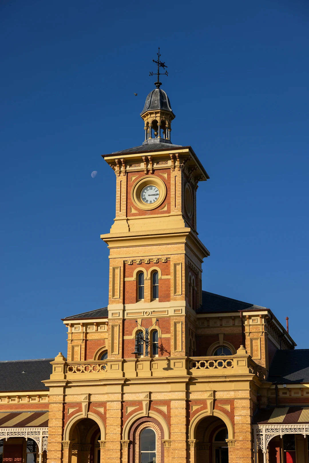 Historic clock tower against a clear blue sky.