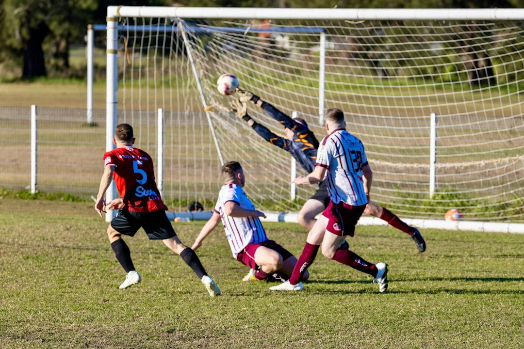Goalkeeper dives to save a soccer goal