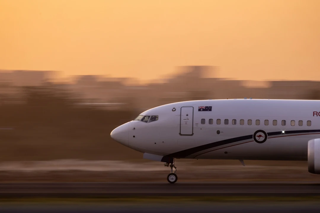 An airplane takes off during a sunrise.