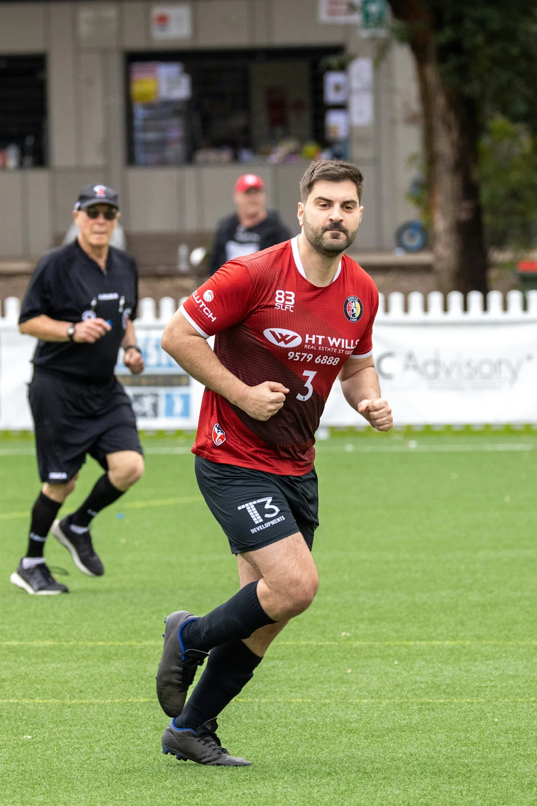 Soccer player running on a green field