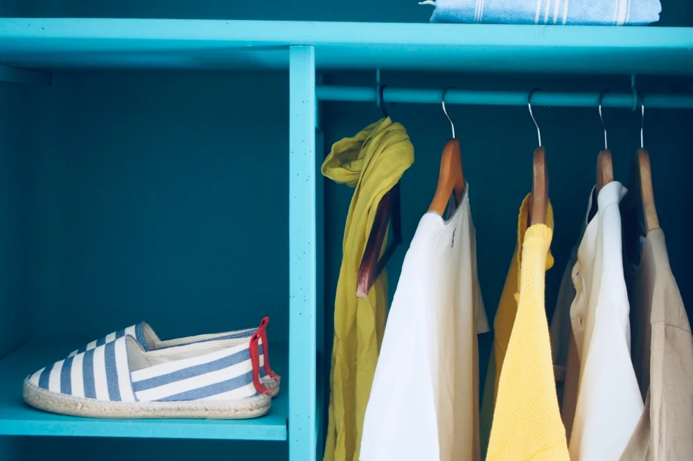 Clothes and shoes in a blue wardrobe