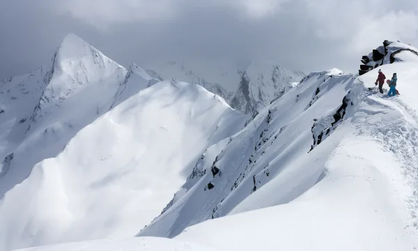 Two snowboarders in the Alps