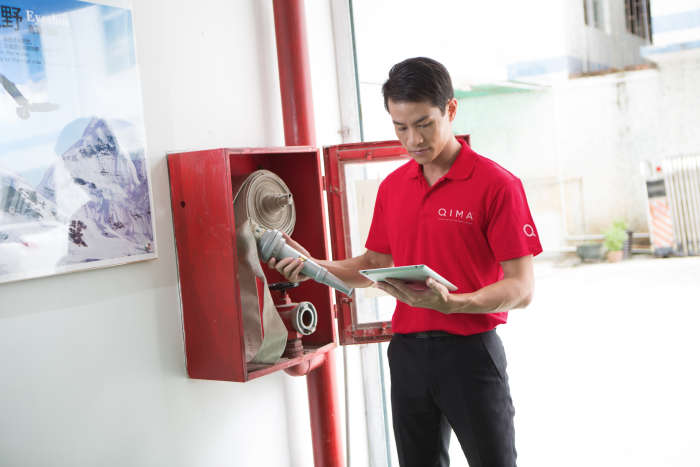 inspector inspecting fire extinguisher 