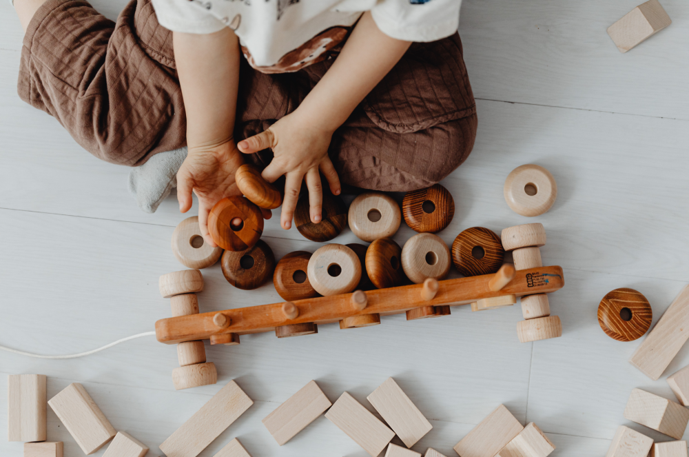a child playing with wooden toys
