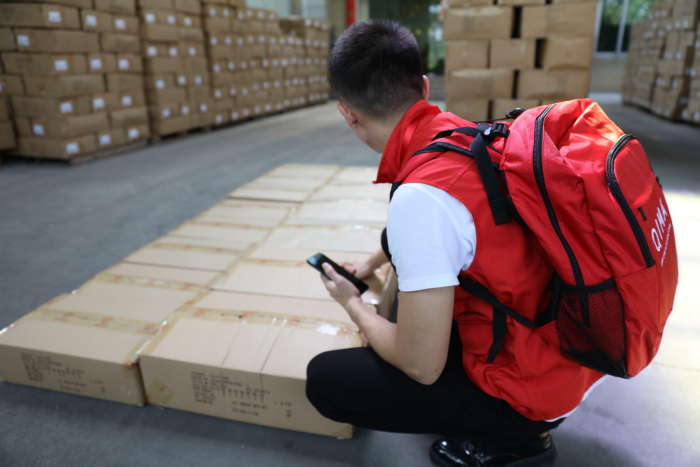 inspector reviewing boxes in a facility