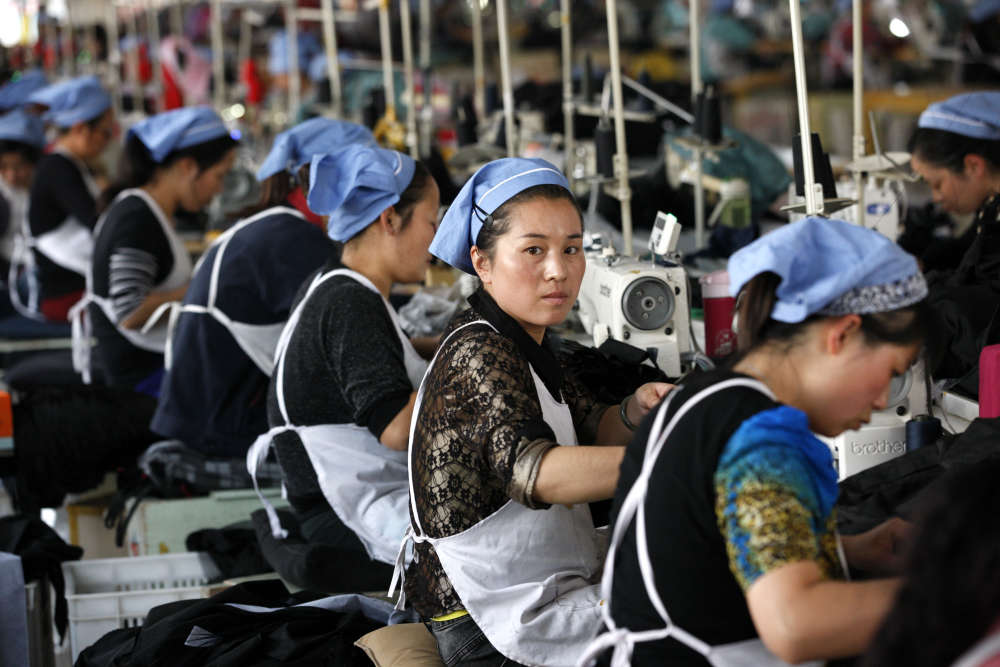 a group of women sewing at a factory