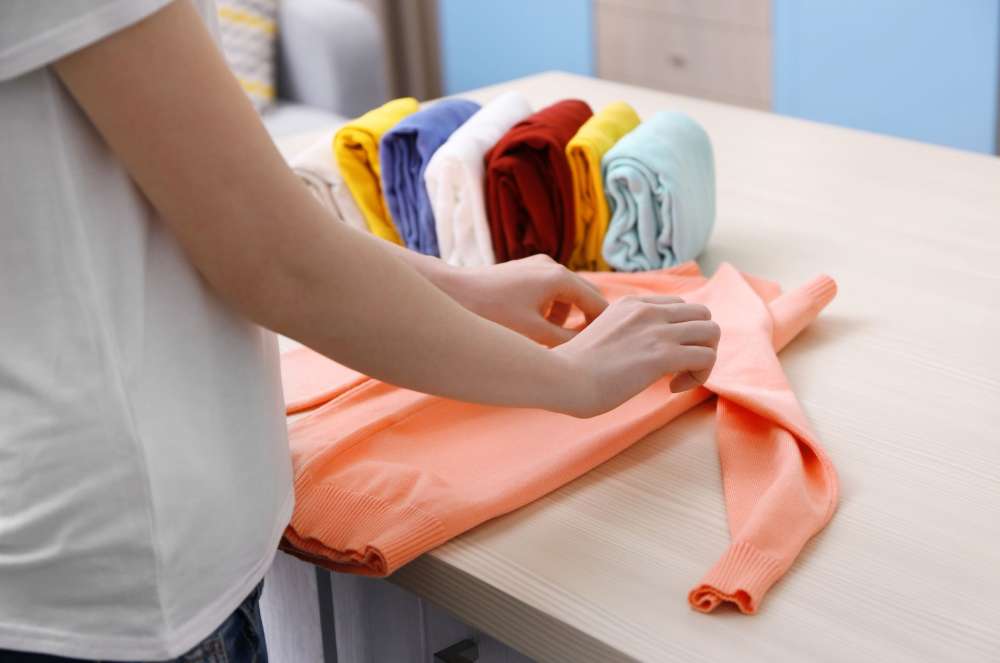 close up shot of a person folding clothes