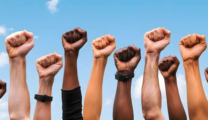 Diverse Group of Fists Raised in Protest
