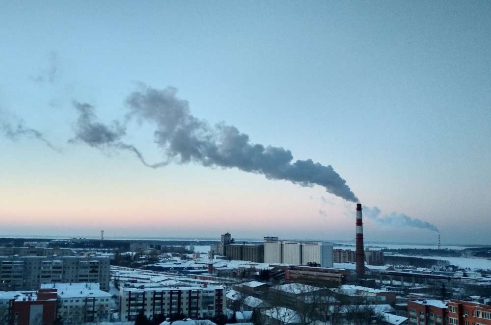 a smoke coming out of a a factory chimney