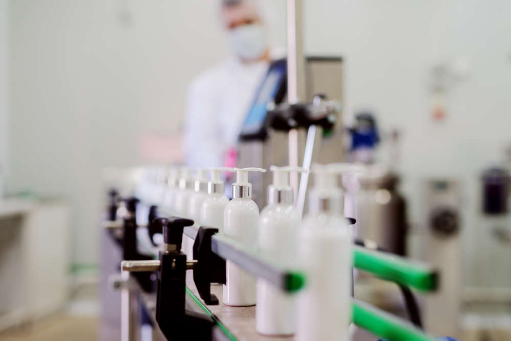 bottles of lotions being produced and checked at a cosmetics factory