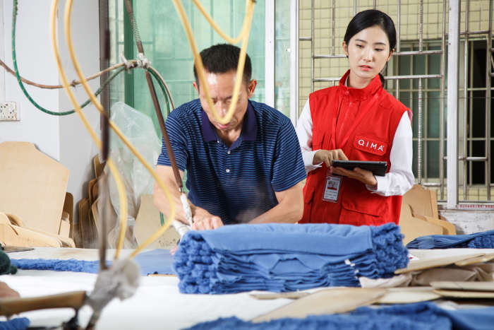 QIMA supplier audit - auditor carrying out an audit at a garment factory