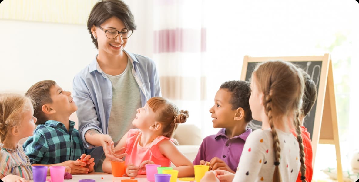 early educator surrounded by their students