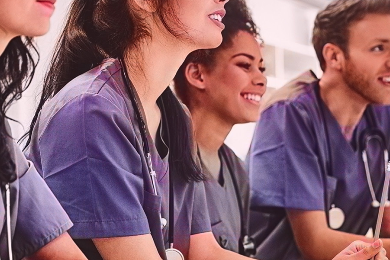 healthcare colleagues sitting together smiling